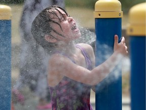 Files: A young girl basks in the cold spray of water at a splash pad in Barrhaven