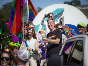 Mayor Jim Watson (black T-shirt) and Coun. Laura Dudas participate in the 2019 Capital Pride Parade. Activists would like to see the city take action against 'conversion therapy.'