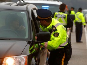 RCMP Traffic Services and Alberta Sheriffs are seen conducting a roadside sobriety test at a Checkstop leading into the Victoria Day long weekend on Highway 22 outside Bragg Creek. Thursday, May 16, 2019.