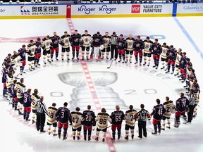 TORONTO, ONTARIO - JULY 30: The Boston Bruins and the Columbus Blue Jackets gather at center ice prior to their exhibition game before the 2020 NHL Stanley Cup Playoffs.
