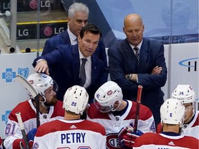 Files: Head coach Claude Julien, right, listens as assistant coach Luke Richardson of the Montreal Canadiens talks with players in August, 2020.