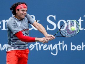 Milos Raonic returns a shot to Stefanos Tsitsipas in their semifinal match on Friday.