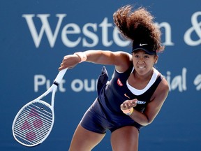 Naomi Osaka serves to Elise Mertens during the Western & Southern Open women's semifinals on Friday in New York.