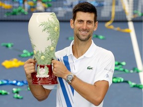 Novak Djokovic of Serbia poses with the winner's trophy after defeating Milos Raonic of Canada in the men's singles final of the Western & Southern Open at the USTA Billie Jean King National Tennis Center on Saturday in the Queens borough of New York City.