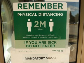 An Algonquin College sign reminds people to keep a safe physical distance from each other.