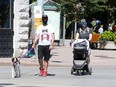 Individuals wearing masks walk in downtown Ottawa on Saturday.