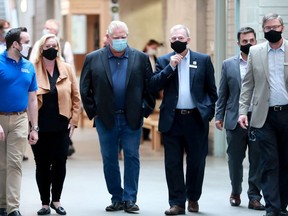 OTTAWA - AUG. 27, 2020 - Ontario Premier Doug Ford (blue mask) toured the construction excellence facility at Algonquin College Thursday. Others included (from left): MPPs Jeremy Roberts and Lisa McLeod, Algonquin College President Claude Brulé, the college's manager of government relations and former city councillor, Michael Qaqish, and Sr. VP of Academics at the college, Chris Janzen.