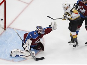 Vegas Golden Knights forward Jonathan Marchessault (81) tips a shot past Colorado Avalanche goaltender Philipp Grubauer (31) during the second period in the Western Conference qualifications at Rogers Place in Edmonton, Aug. 8, 2020.