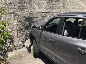A 79-year-old woman suffered minor injuries in this crash into a cinderblock wall Friday. Firefighters stabilized the building and isolated damaged electrical wiring
