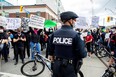 Protesters march to highlight the deaths of Toronto's Regis Korchinski-Paquet, who died after falling from an apartment building while police officers were present, and in the officer-involved deaths of Ahmaud Arbery, Breonna Taylor and George Floyd in the U.S., in Toronto on May 30, 2020.