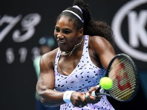 Serena Williams plays a shot during an Australian Open match in Melbourne in January. Williams says she's pressing ahead with plans to plan in the U.S. Open despite a wave of withdrawals by other players in the men's and women's divisions.
