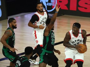 Raptors forward Pascal Siakam (43) is defended by Celtics forward Semi Ojeleye (37) during the fourth quarter of Sunday's game.