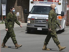 Members of the Canadian Armed Forces in front of Pickering's Orchard Villa long-term care home on May 6.