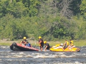 Ottawa firefighters assist three people whose personal water craft was stranded in the Deschênes Rapids Thursday morning.