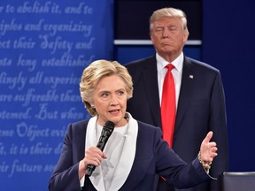Republican presidential candidate Donald Trump listens to Democratic presidential candidate Hillary Clinton during a debate at Washington University in St. Louis, Missouri on Oct. 9, 2016.