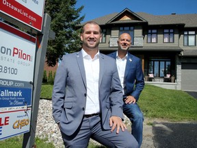 Remax broker Jason Pilon (right) and sales rep Erik Faucon in front of the home at 119 Saphir Ave.