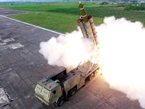 A missile is fired during the test of a multiple rocket launcher in this undated photo released on August 25, 2019 by North Korea's Korean Central News Agency (KCNA).