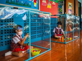 Thai kindergarteners wear face masks as they play in areas used for social distancing at the Wat Khlong Toey School on Aug. 10, 2020 in Bangkok, Thailand.