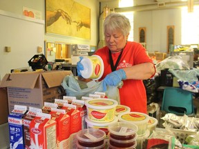 A volunteer packs food in Sarnia, Ont. earlier this year as part of a fundraising campaign help stock shelves with school snacks.