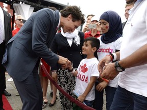 Prime Minister Justin Trudeau greets members of a Syrian refugee family during Canada Day celebrations on Parliament Hill in 2016. Initially, his government recognized the link between good refugee policy and sound public health practices.
