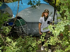 A resident packs up as police and City of Ottawa staff prepare to dismantle a tent city behind a field at the corner of Enfield Street and Grant Tool Way last Thursday.