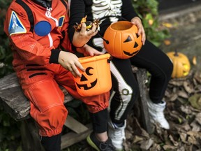 Little children trick-or-treating on Halloween