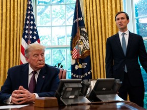 Advisor Jared Kushner (R) speaks as U.S. President Donald Trump listens in the Oval Office to announce that Bahrain will establish diplomatic relations with Israel, at the White House in Washington, DC on September 11, 2020. The announcement follows one last month by Israel and the United Arab Emirates that they would seek to normalize relations with each other.