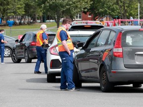 Long lineups at Brewer Park's COVID-19 assessment centre Monday. In fact, cars were lined up at times out to Bronson Avenue.