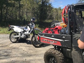 Firefighters pulled this dirt bike and its rider from deep mud on a bush trail in Dunrobin area Thursday.