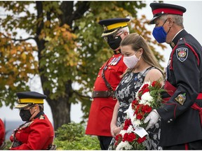 Tricia Kirkwood lays a wreath at the Canadian Police and Peace Officers 43rd Annual Memorial Service behind Parliament Hill at the Summer Pavilion