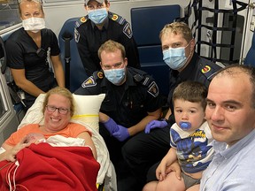 Paramedics with the happy parents after the responders assisted at an at-home birth