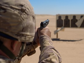 A Canadian Forces member practices firing the Browning 9mm pistol. (Canadian Forces photo)