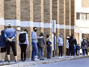 People line up at a COVID assessment centre in Toronto.