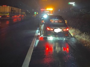 Ontario Provincial Police officers stopped a 19-year-old driver speeding down Highway 401 in the pouring rain early Wednesday with a bong in his lap.