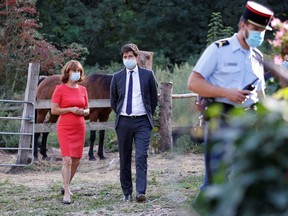 French Agriculture Minister Julien Denormandie speaks with horse breeder Mireille Didier on the sidelines of a meeting with local authorities and horse breeders whose animals have been victims of mutilation attacks in Plailly, France, September 7, 2020.
