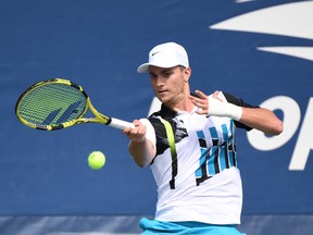 Miomir Kecmanovic of Serbia hits a forehand.