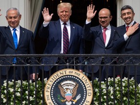 Israeli Prime Minister Benjamin Netanyahu, US President Donald Trump, Bahrain Foreign Minister Abdullatif al-Zayani, and UAE Foreign Minister Abdullah bin Zayed Al-Nahyan wave from the Truman Balcony at the White House after they participated in the signing of the Abraham Accords where the countries of Bahrain and the United Arab Emirates recognize Israel, in Washington, DC, September 15, 2020.