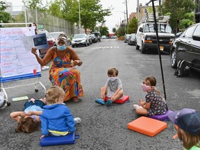 A teacher conducts a lesson with students during an outdoor learning demonstration for New York City schools on Sept. 2 in Brooklyn.