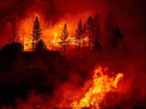 Files: A home is engulfed in flames during the "Creek Fire" in the Tollhouse area of unincorporated Fresno County, California early on September 8, 2020.