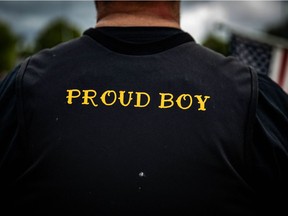 A man wears a Proud Boy vest