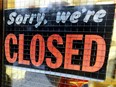 A file photo of a store closed sign.