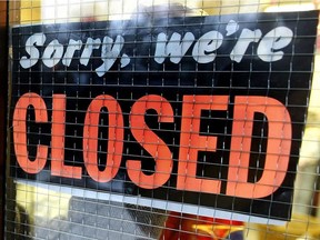 A file photo of a store closed sign.