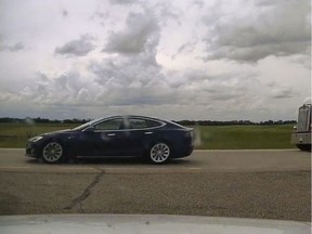 A Tesla car with no visible driver behind the wheel is shown in this RCMP handout photo on Thursday, July 9, 2020 near Ponoka, Alta. RCMP have charged a BC man with dangerous driving after pulling over a speeding Tesla on an Alberta highway that appeared to be driving itself. The incident occurred two months ago near Ponoka in central Alberta.