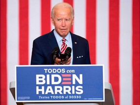 Democratic Presidential Candidate Joe Biden plays music from his cell phone as he participates in a Hispanic Heritage Month event at the Osceola Heritage Park in Kissimmee, Florida on September 15, 2020.