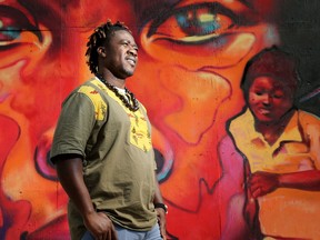 OTTAWA - SEPT. 16, 2020 -  Afro-Canadian poet/rapper Wise Atangana in front of the "We Got' Be Alright" mural at Lisgar and Bank Street.