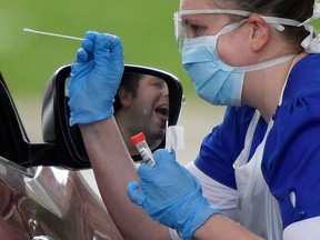 Medical staff are seen testing people at a coronavirus test centre in Britain in early April.