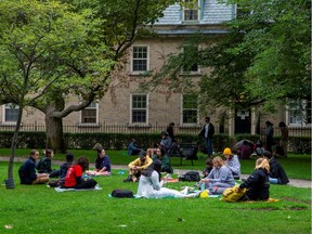 People sit on the grounds of the University of Toronto in Toronto, Ontario, Canada September 9, 2020. Picture taken September 9, 2020.