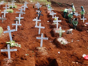 FILE: Workers prepare new graves at the Christian burial area provided by the government for victims of COVID-19 at Pondok Ranggon cemetery complex in Jakarta, Indonesia, September 16, 2020.