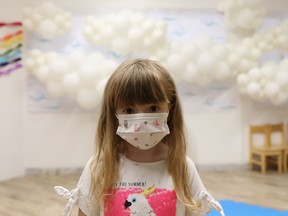 A girl wearing a protective face mask.