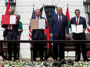 Bahrain's Foreign Minister Abdullatif Al Zayani, Israel's Prime Minister Benjamin Netanyahu and United Arab Emirates (UAE) Foreign Minister Abdullah bin Zayed display their copies of the signed agreements while  U.S. President Donald Trump looks on during the signing ceremony of the Abraham Accords, normalizing relations between Israel and some of its Middle East neighbours.